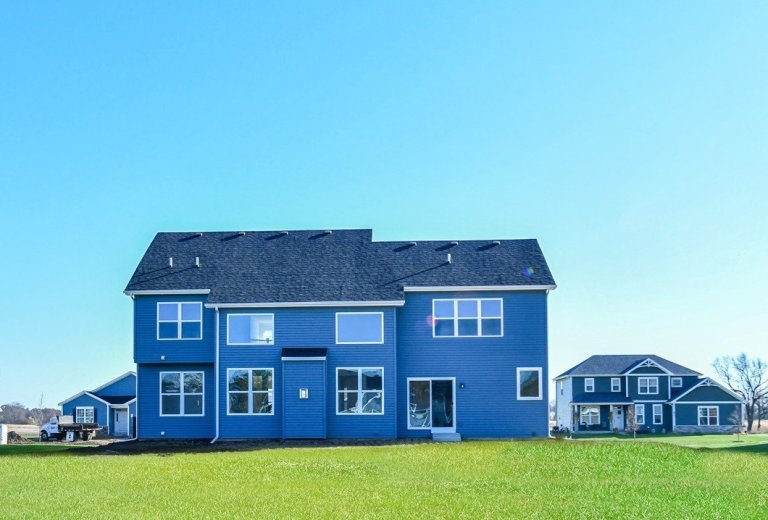 Back exterior of the Gerstad Builders Georgian new construction home featuring a two-story rear elevation and open backyard layout.