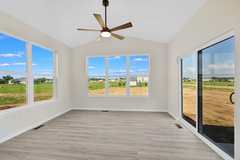 Sunroom in the Gerstad Builders Truman new construction home featuring expansive windows, bright natural light, and private outdoor access.